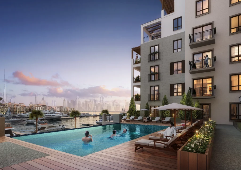 Port de La Mer apartment building with pool terrace and sun loungers, marina and Dubai skyline (developer rendering)