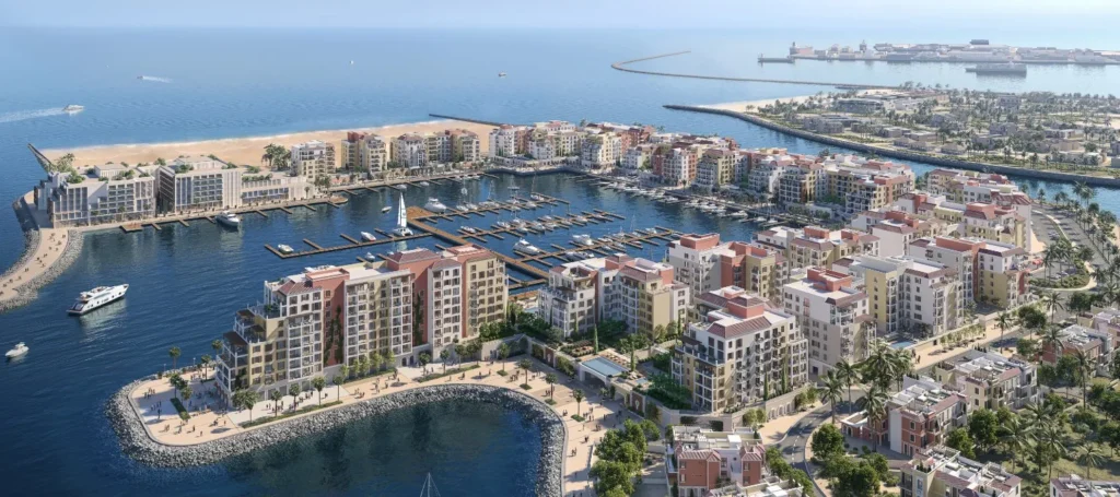 Aerial view of the Port de La Mer island peninsula and Le Soleil waterfront buildings (developer rendering)