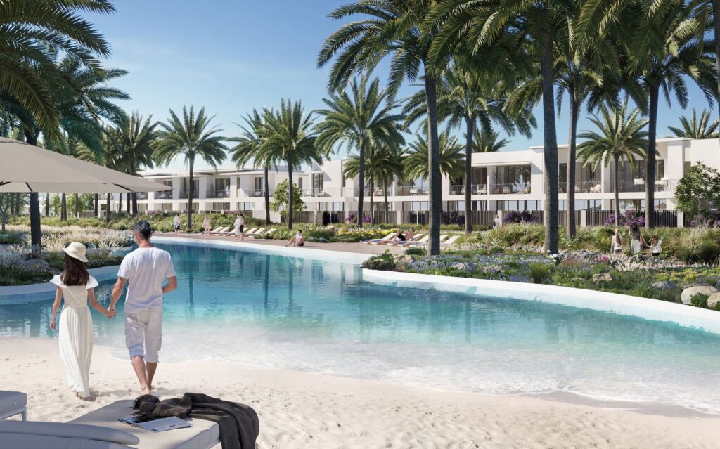 Pool with palm trees and modern low-rise buildings