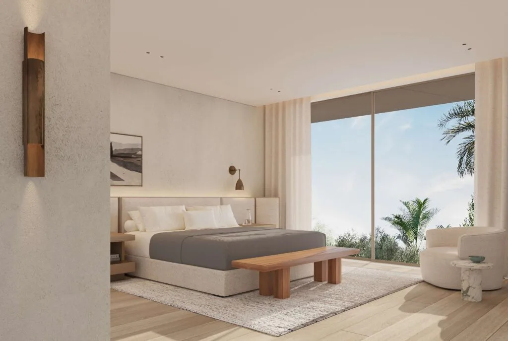 Master bedroom interior with large window and garden view