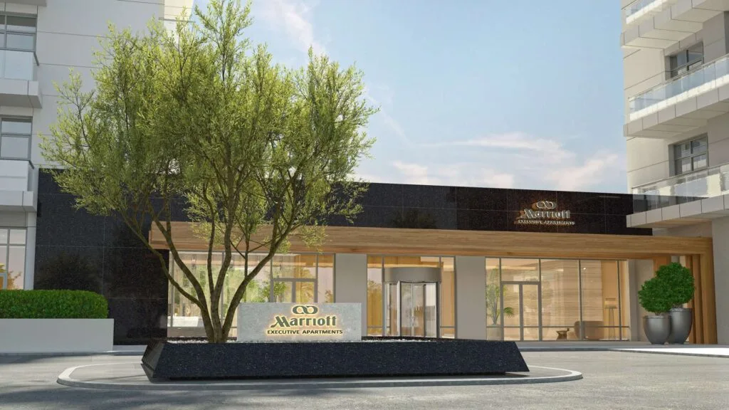 Exterior view of Marriott Executive Apartments entrance with tree