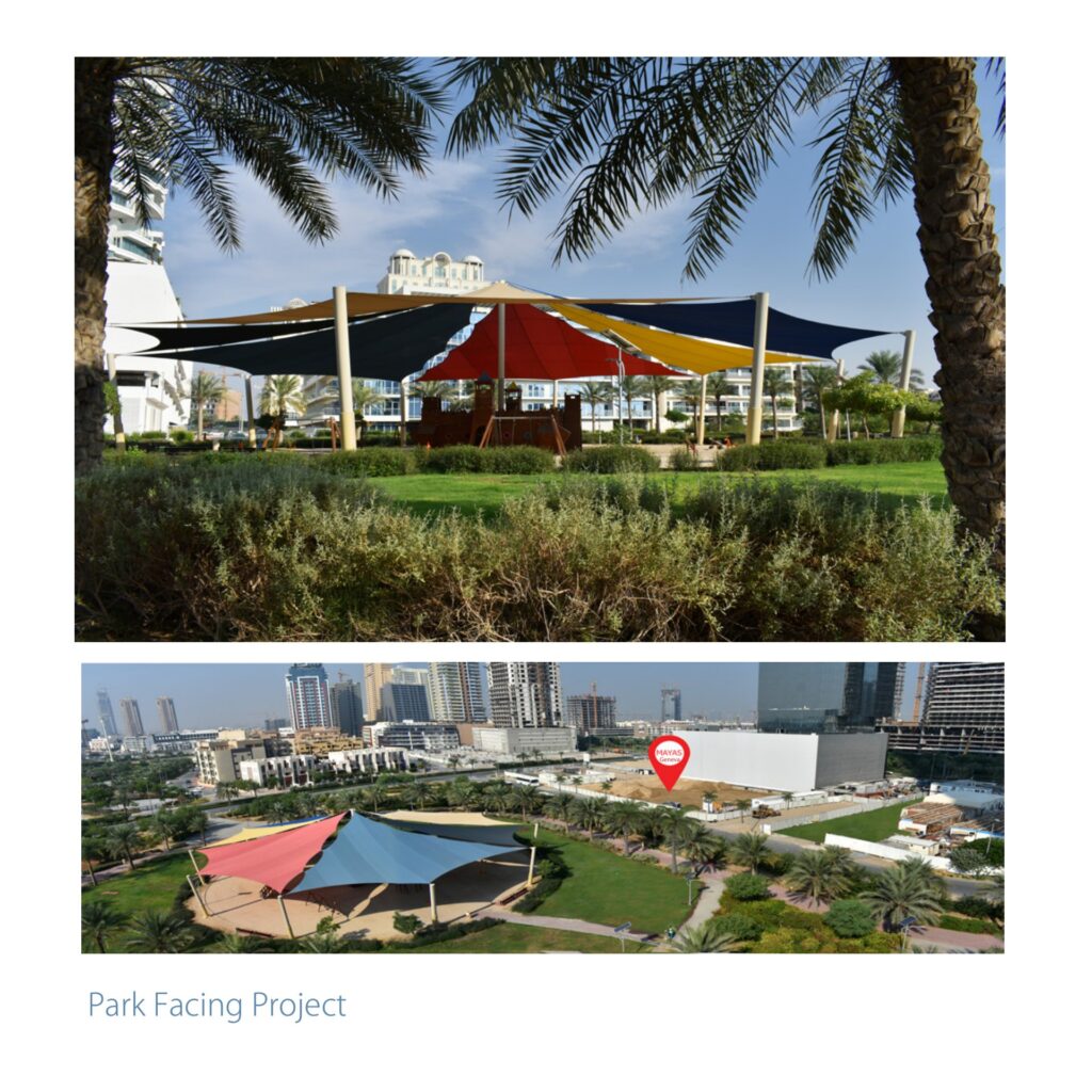 Park area with colorful shade structures and surrounding greenery