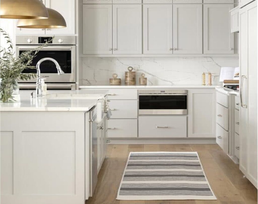 modern kitchen interior with white cabinets and striped rug