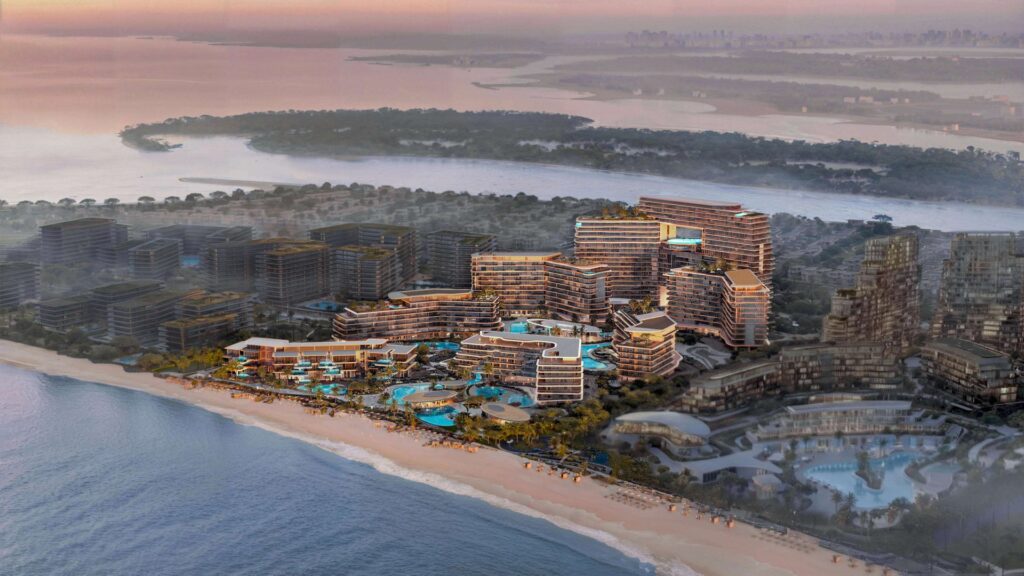 Aerial view of beachfront buildings and pools at sunset