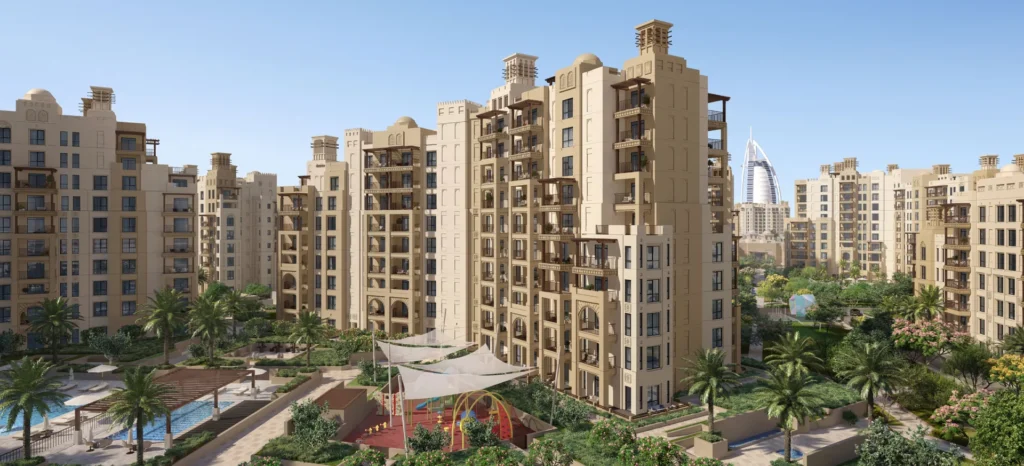Madinat Jumeirah Living Al Jazi residential buildings with landscaped courtyard under clear sky (developer rendering)
