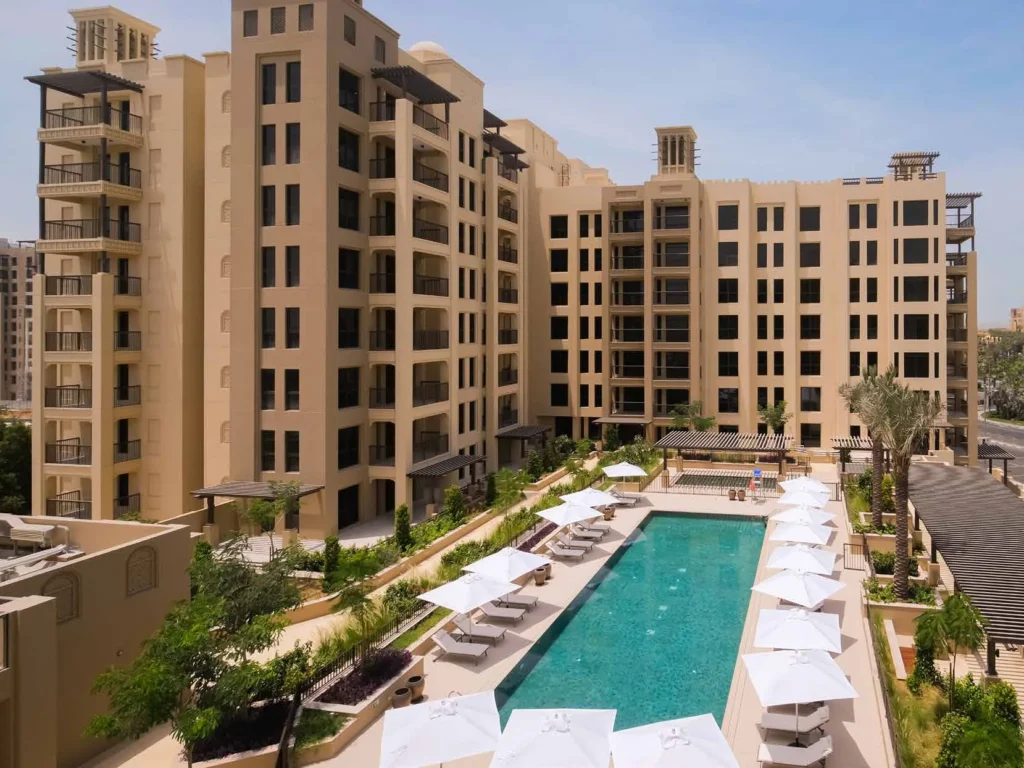 Lamtara apartment building overlooking a landscaped swimming pool deck (developer rendering)