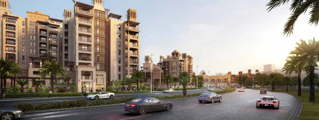 Lamtara residential buildings at dusk beside a road with palms (developer rendering)