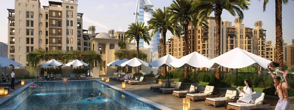 Resort-style pool with loungers and parasols in front of Lamtara buildings (developer rendering)