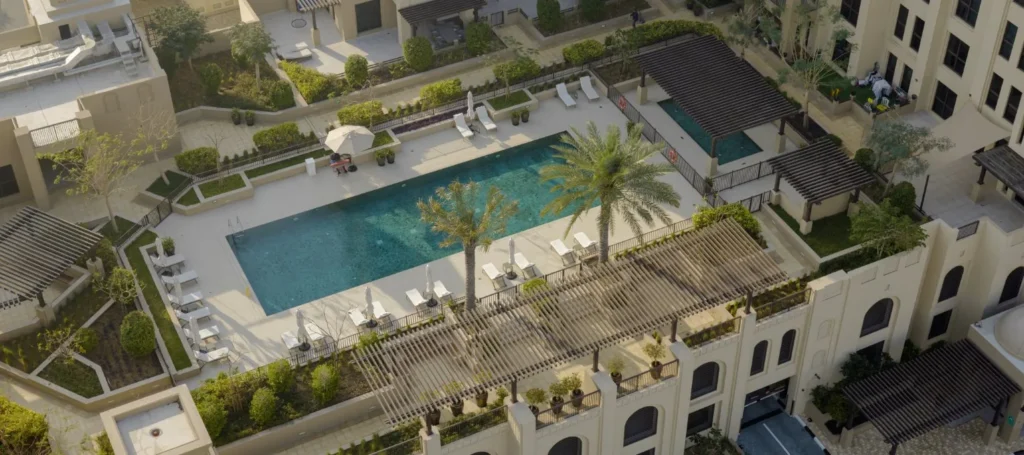 Rahaal rooftop pool terrace seen from above with surrounding apartment blocks (developer rendering)