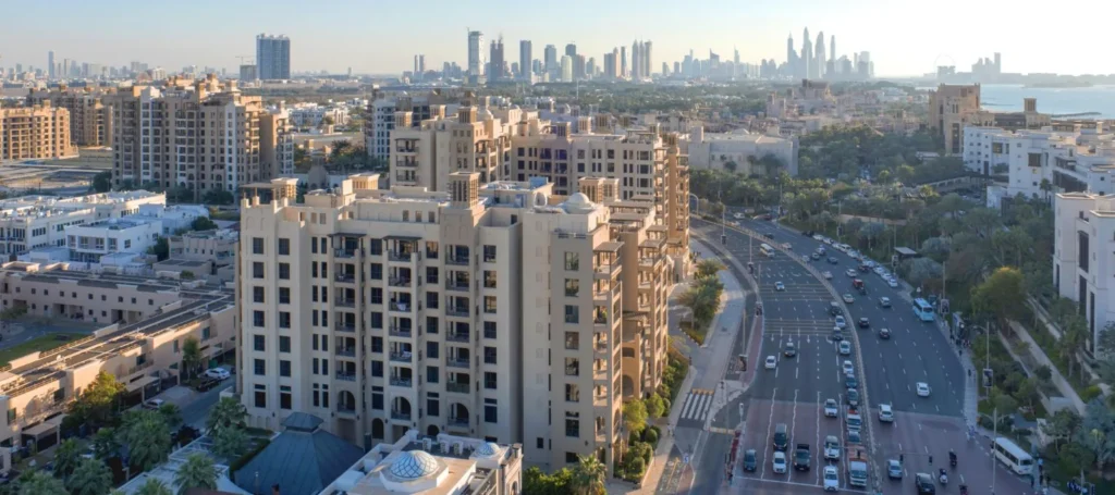 Rahaal buildings beside the main road with Dubai skyline behind (developer rendering)