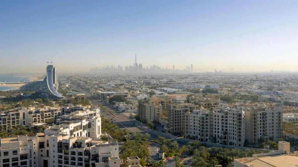 Aerial photograph of Madinat Jumeirah Living residential buildings with Burj Al Arab and Jumeirah coast
