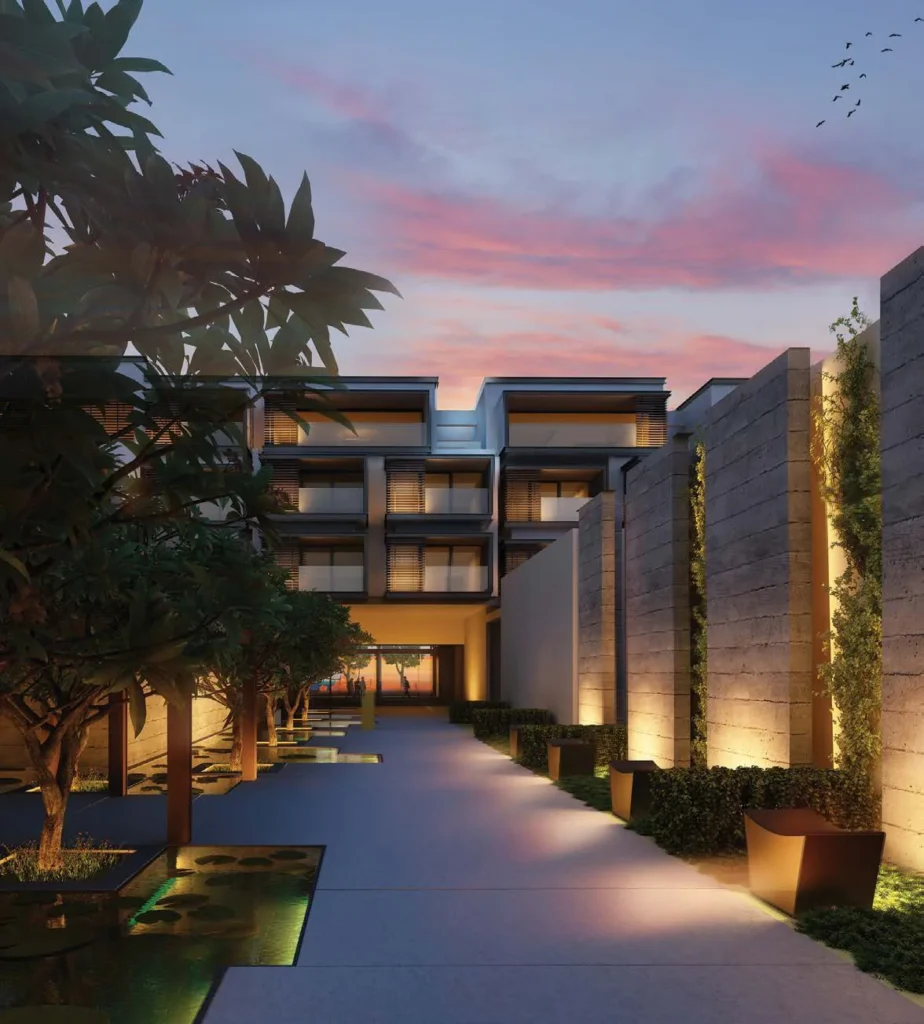 Lit walkway between Nikki Beach Residences blocks at dusk (developer rendering)