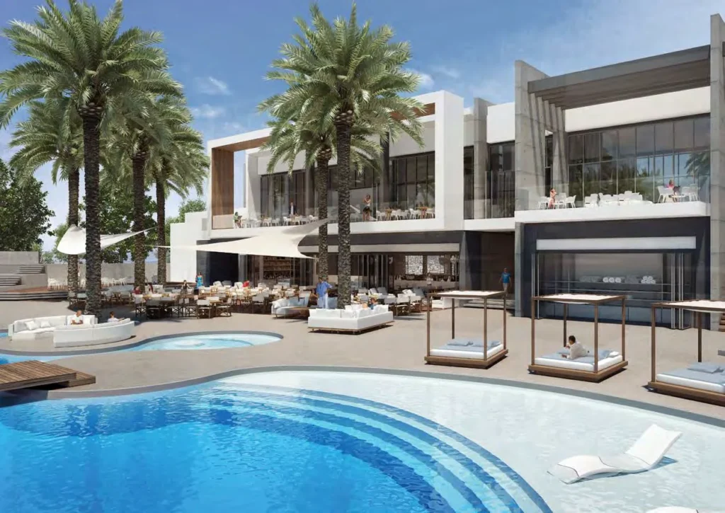 Nikki Beach Residences pool deck with daybeds and palms (developer rendering)