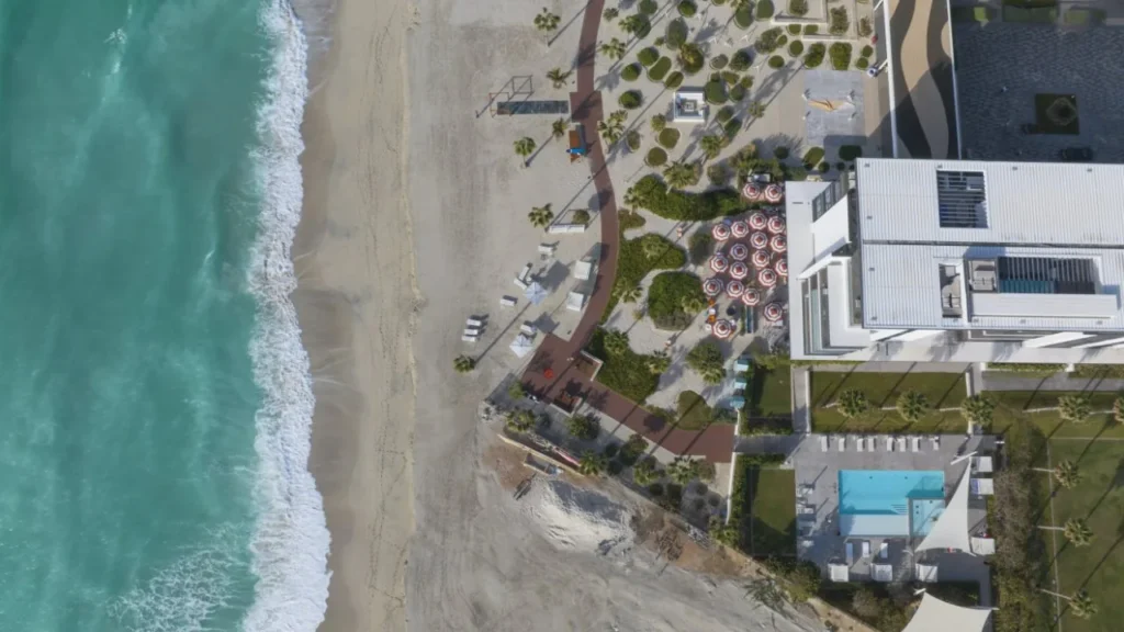 Top-down aerial view of the beach and Nikki Beach Residences pool terrace