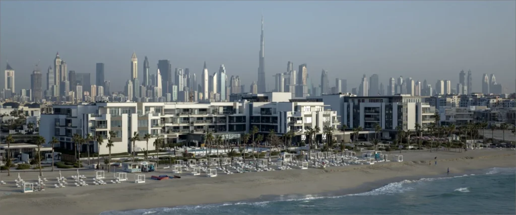 Nikki Beach Residences Dubai beachfront with Dubai skyline and Burj Khalifa in the distance