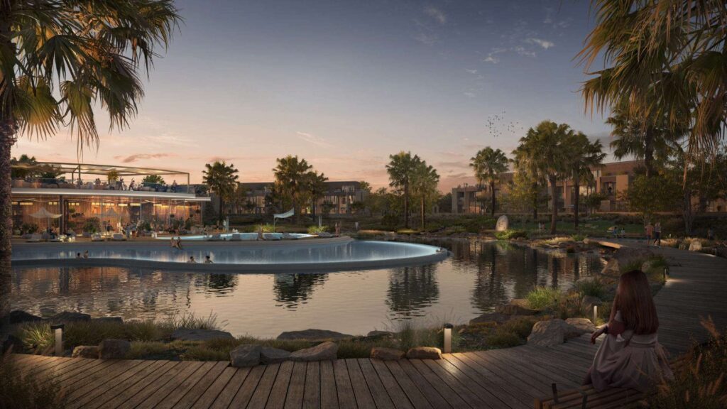 Evening view of clubhouse and pool with surrounding palm trees