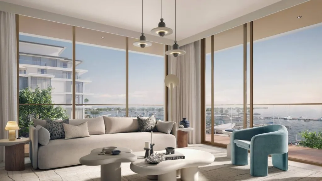 Interior living room with large windows overlooking marina and boats