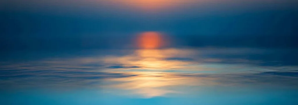 sunset over calm water with project logos