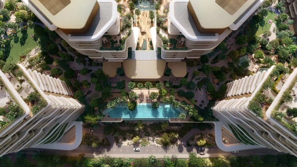 Aerial view of residential towers with pool and landscaped gardens