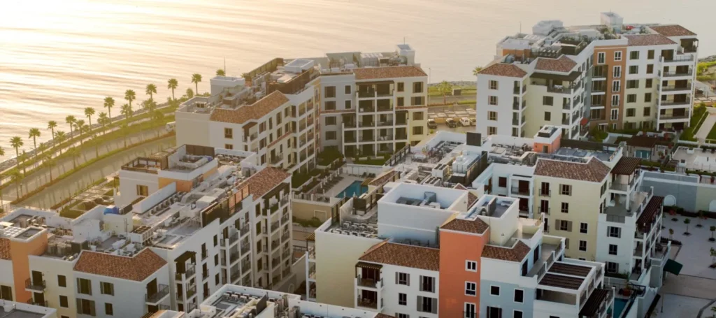 Aerial view of Port de La Mer terraced residential buildings with palm-lined promenade, Dubai (developer rendering)