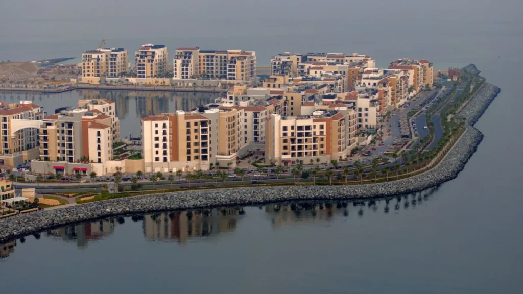 Port de La Mer waterfront residential buildings along the sea edge of the island (developer rendering)
