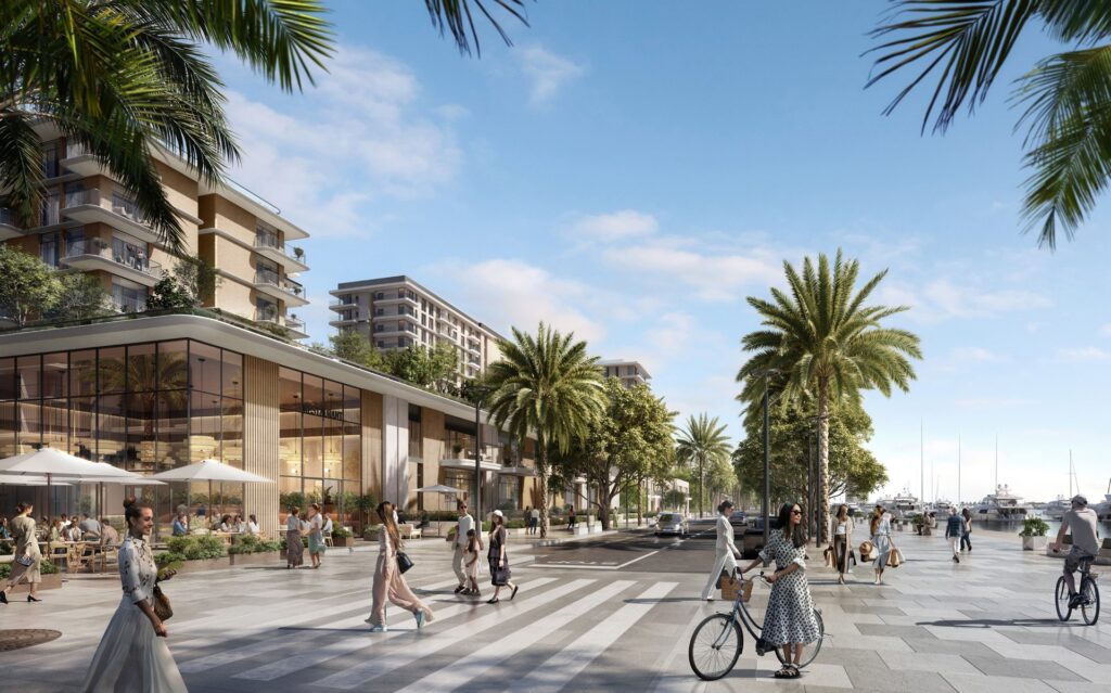 Street view with buildings, palm trees, and waterfront promenade