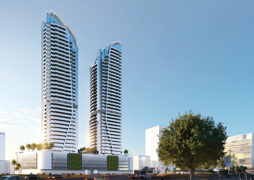Two tall residential towers with balconies and surrounding low-rise buildings