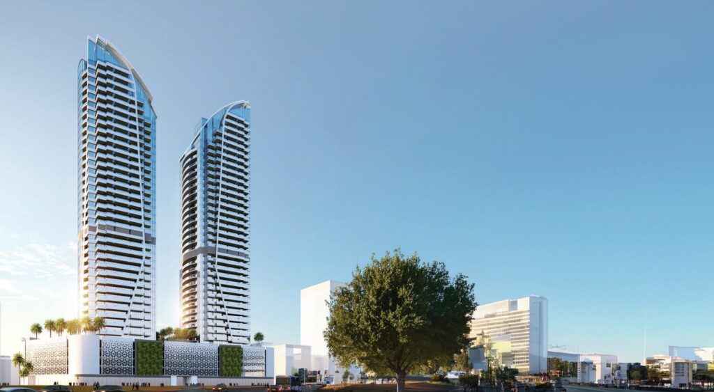 Two tall modern residential towers with surrounding low-rise buildings