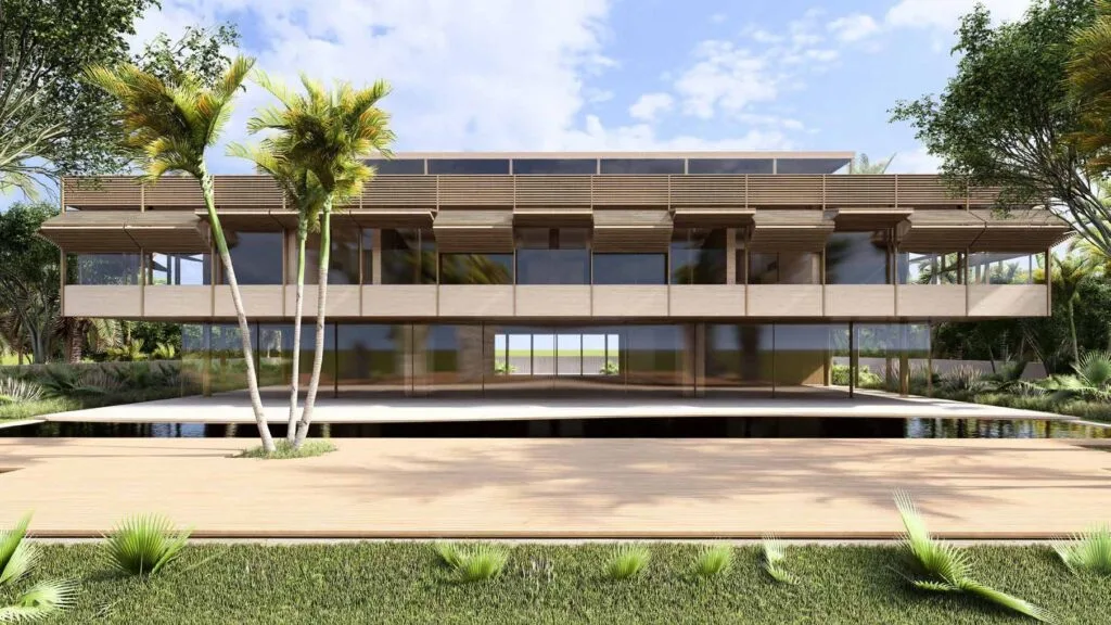 Modern two-story building with large glass windows and surrounding greenery