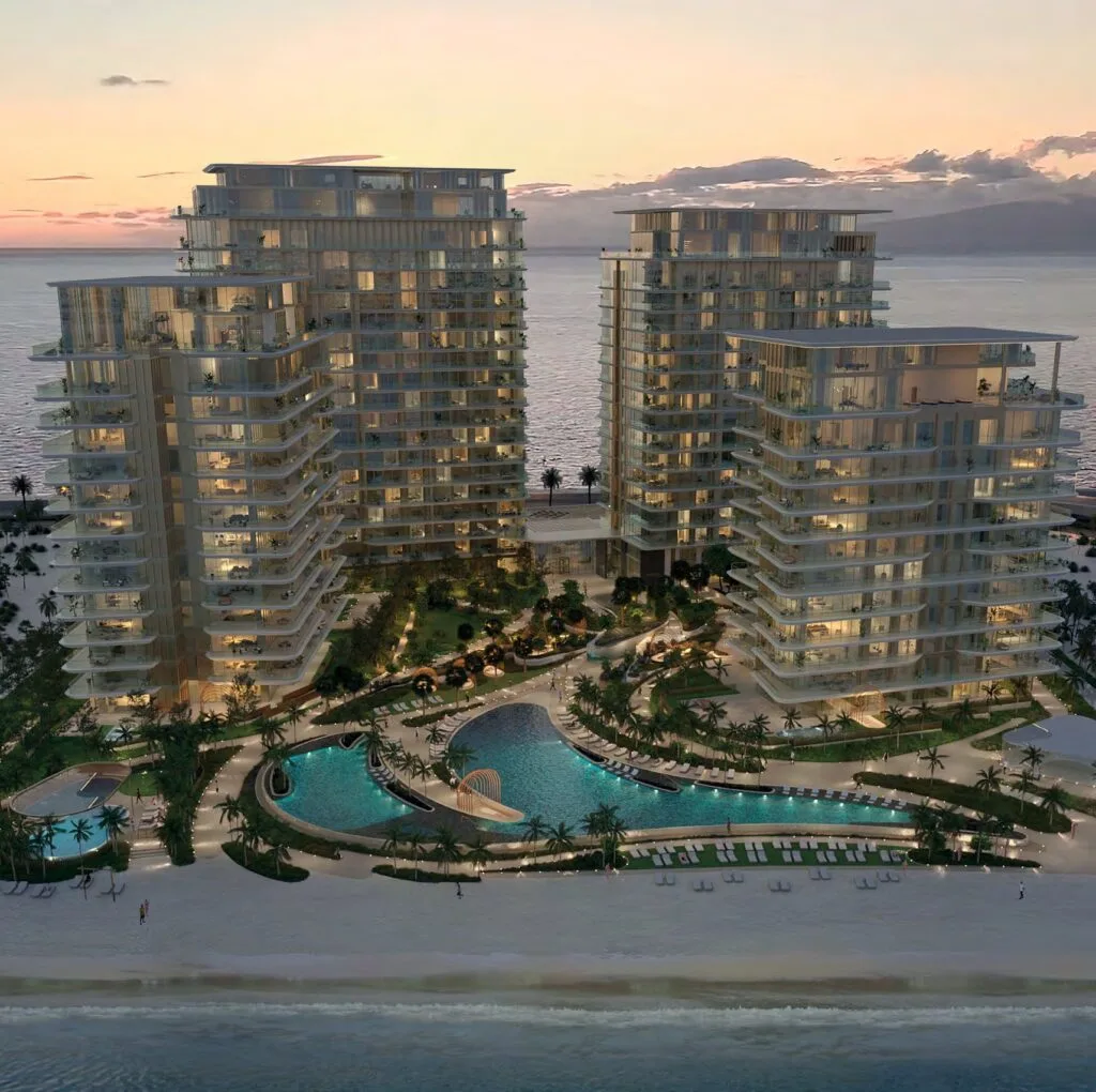Four residential towers by the beach with pools at sunset