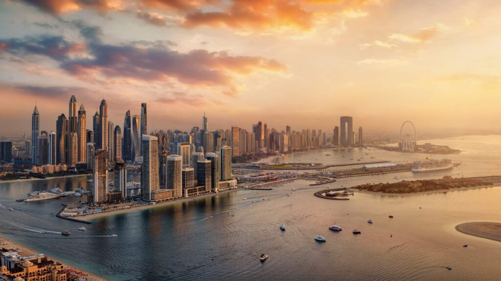 Aerial view of Dubai skyline and waterfront at sunset