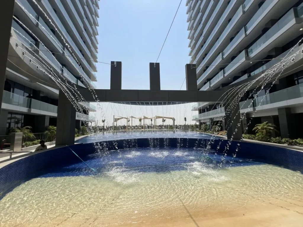 Skyhills Residences podium pool with water features, July 2026