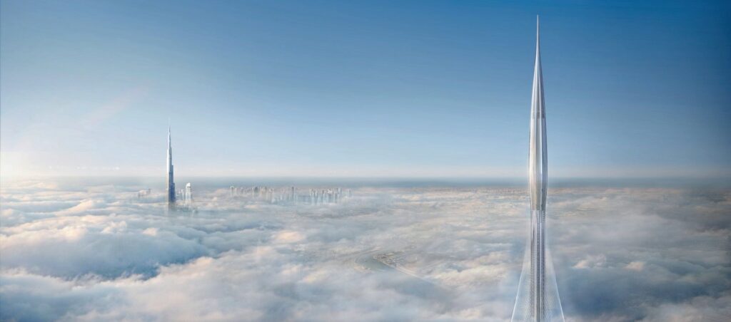 Tall building rising above clouds in city skyline