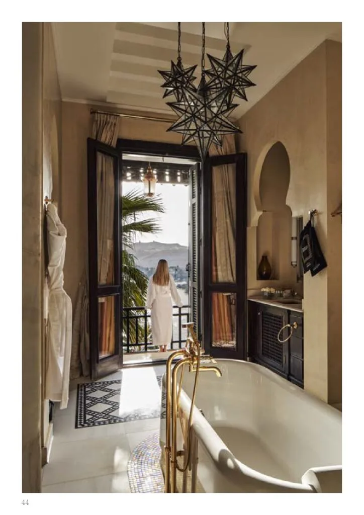 Bathroom with freestanding bathtub and open doors to balcony