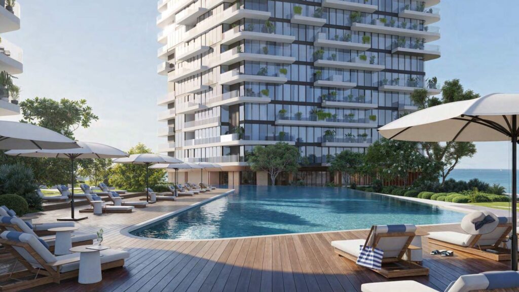 Outdoor pool area with sun loungers and modern building