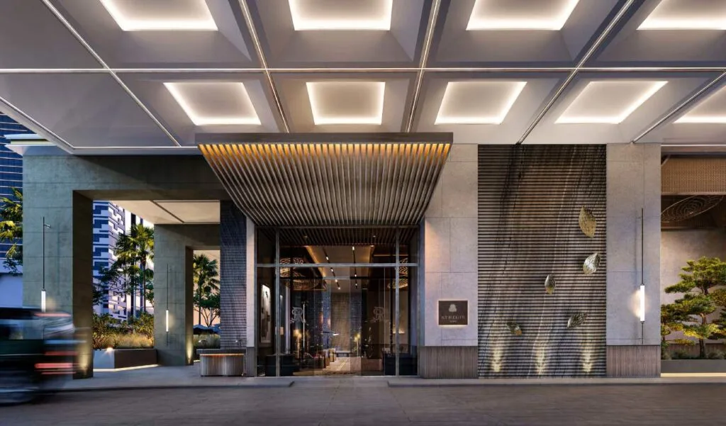 Exterior entrance of a modern building with illuminated ceiling panels