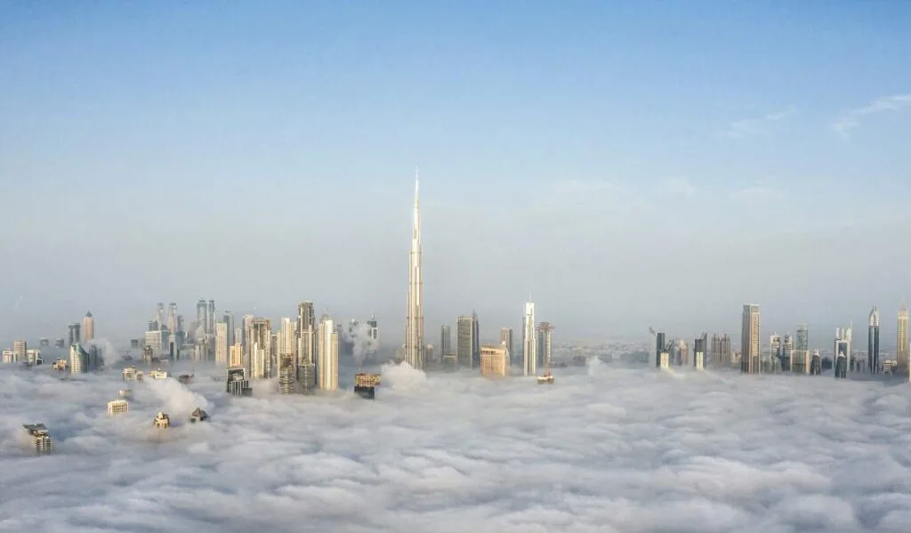 Dubai skyline with Burj Khalifa rising above clouds