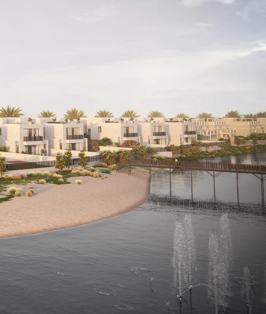 Waterfront view of modern low-rise residential buildings with palm trees