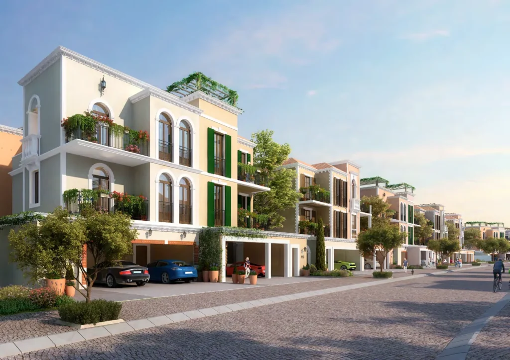 Row of white and cream Sur La Mer townhouses along a cobbled street (developer rendering)