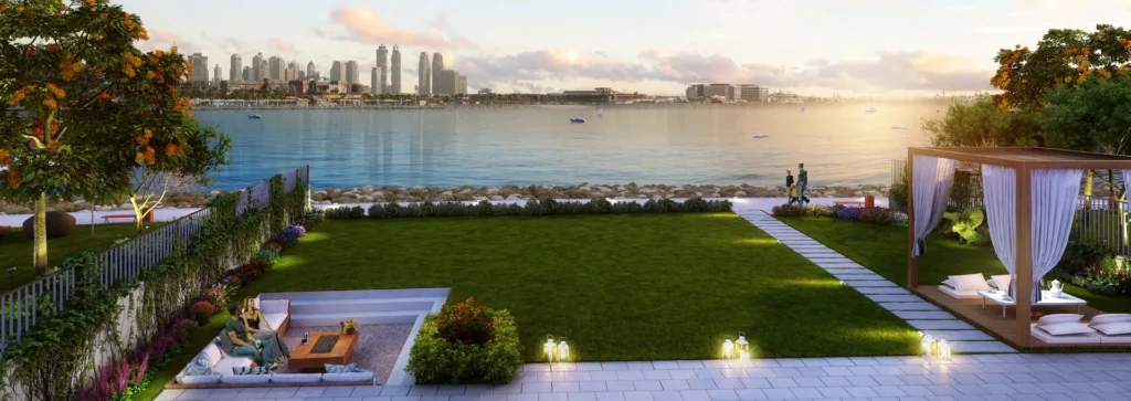 Waterfront townhouse garden with lawn, cabana and dusk view across the bay (developer rendering)