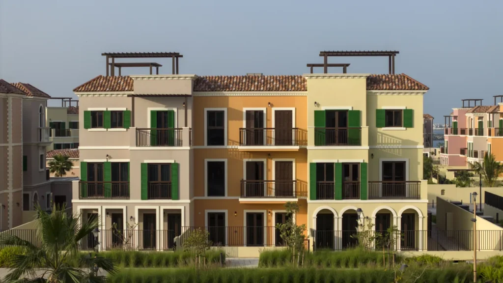 Sur La Mer three-storey townhouse facades with green shutters and roof terraces