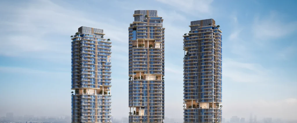 The Edit Tower A by Meraas in Dubai Design District, Dubai — Three modern residential towers above a hazy skyline