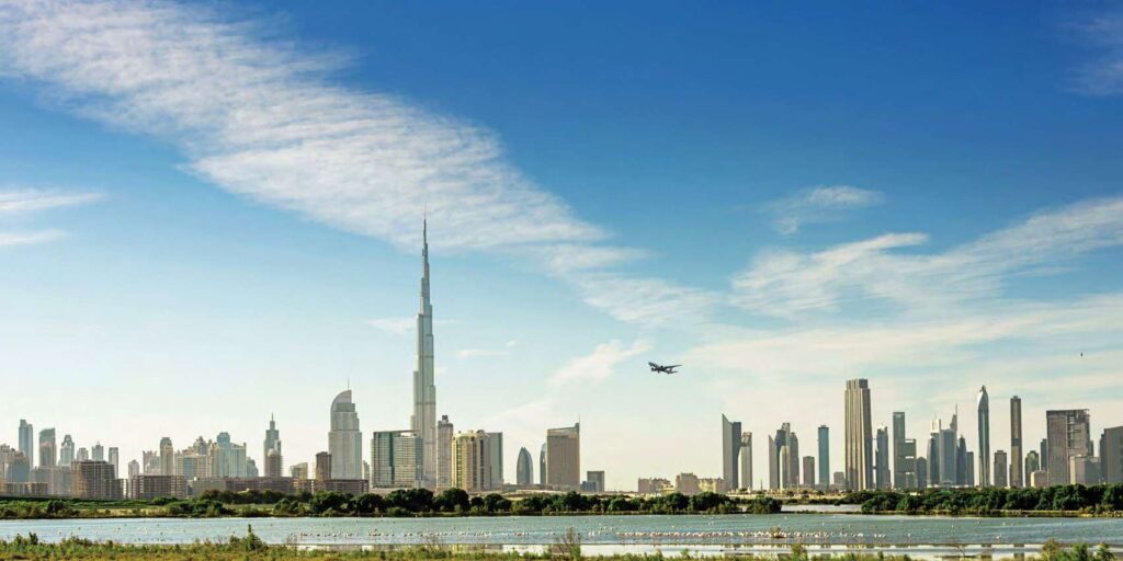 Dubai skyline with Burj Khalifa and an airplane in sky