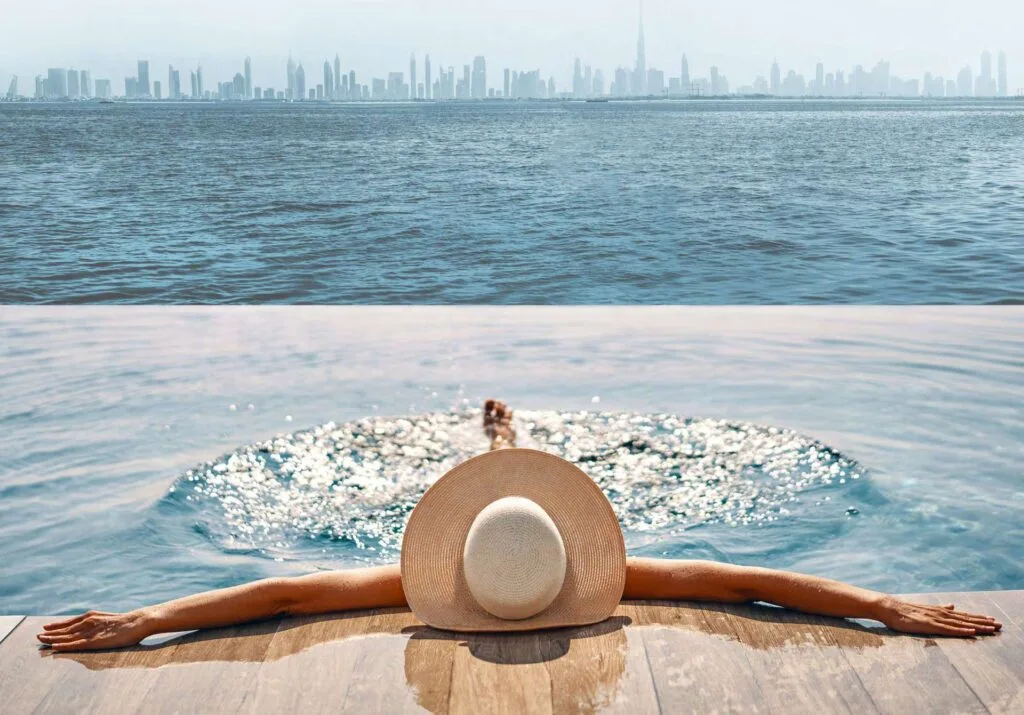 Infinity pool overlooking waterfront and city skyline