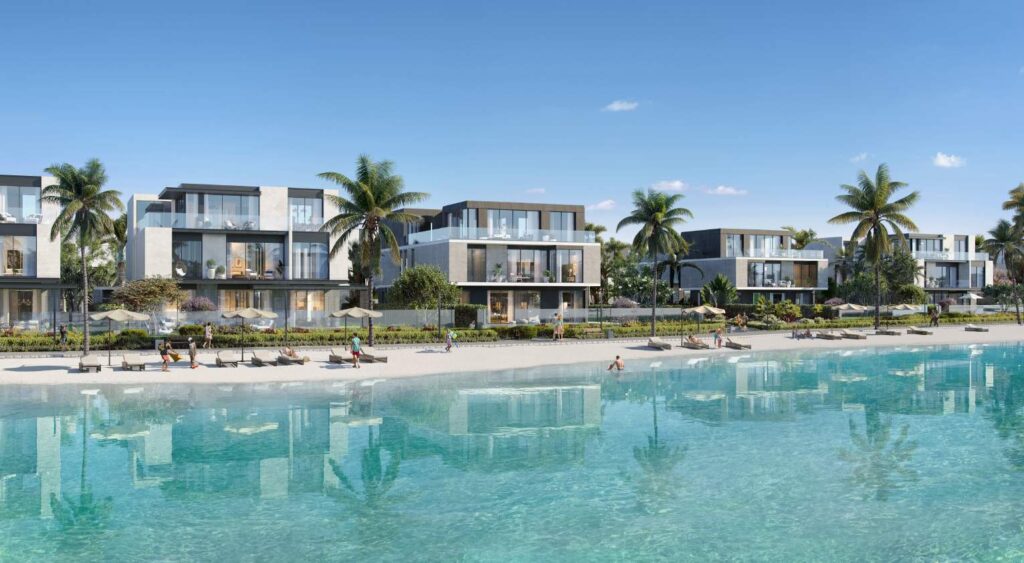 Modern low-rise buildings by a large clear water pool with palm trees