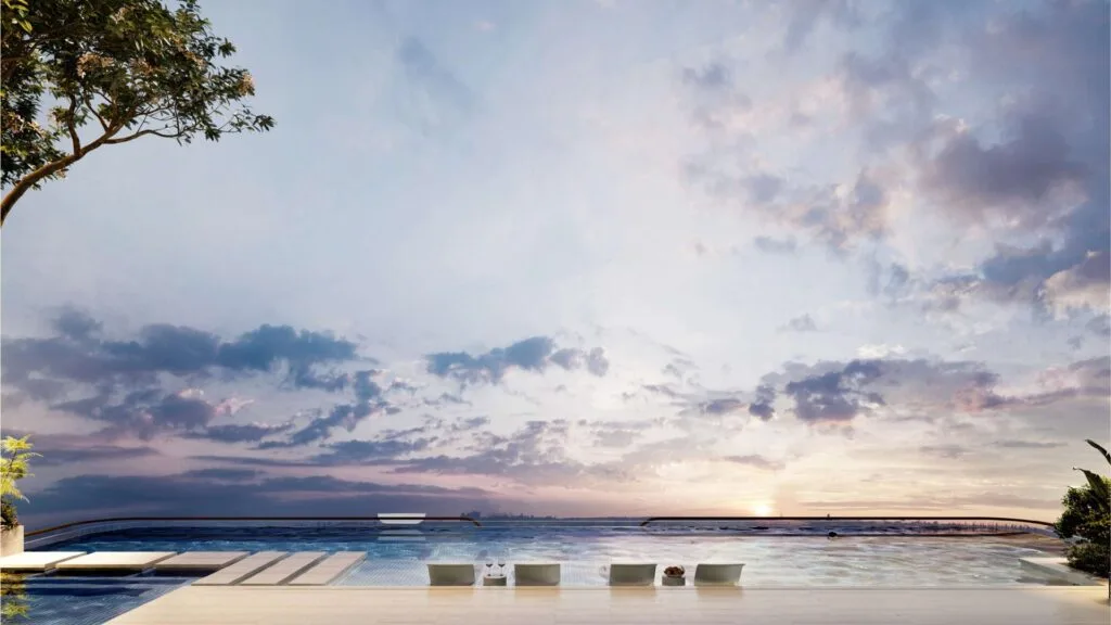 Outdoor swimming pool with seating and sunset sky