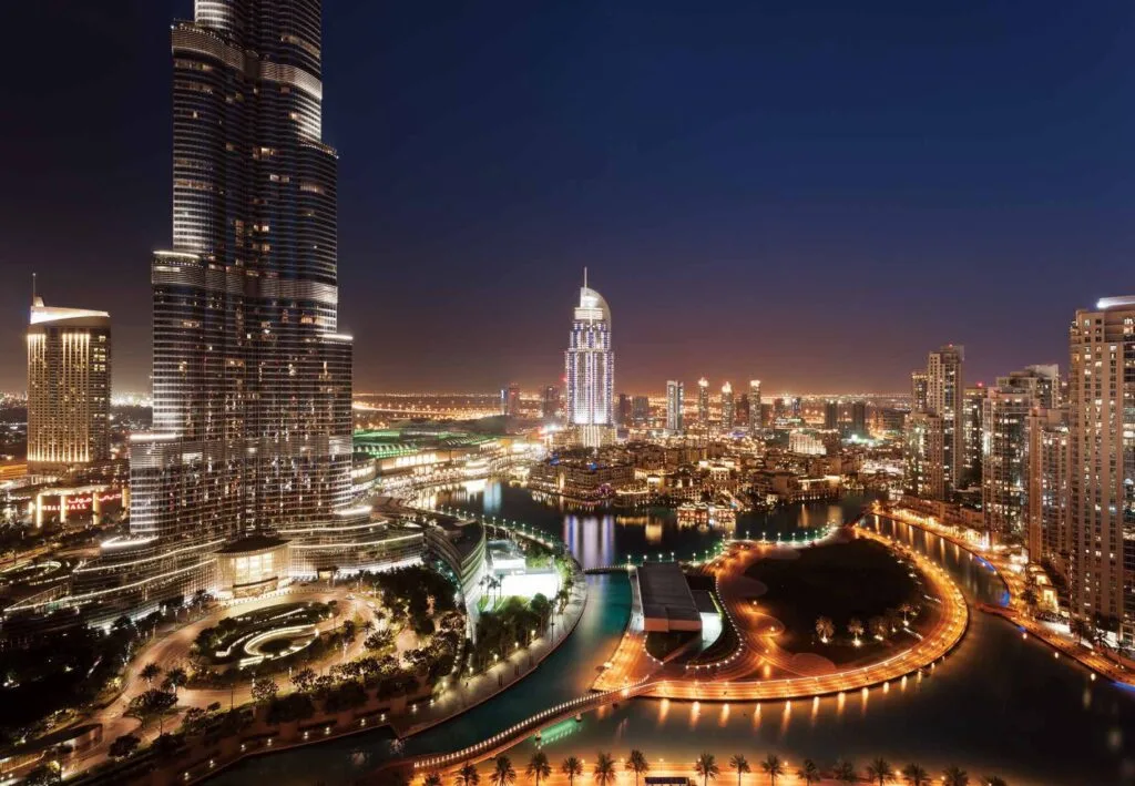 Night view of illuminated high-rise buildings and water canal