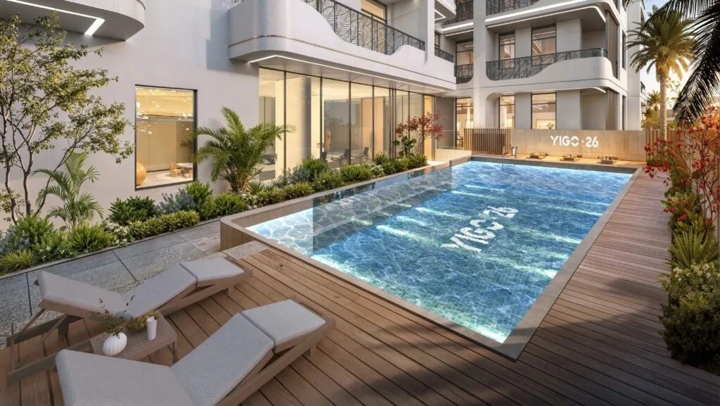 Outdoor pool area with lounge chairs and modern building facade